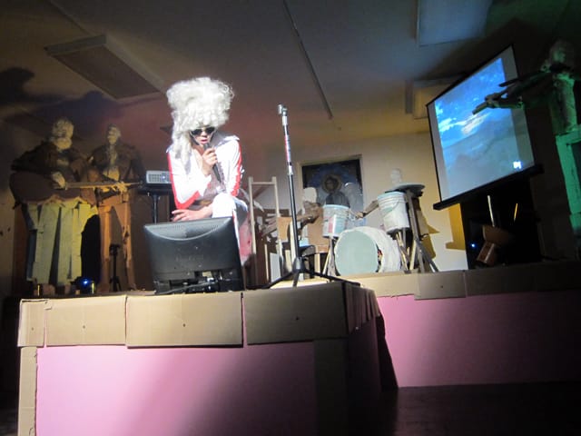 Cate Giordano, "Dolly Presley" performance, curated by Eve Sussman, with a plaster, foam, cardboard, and wood band and back up singers