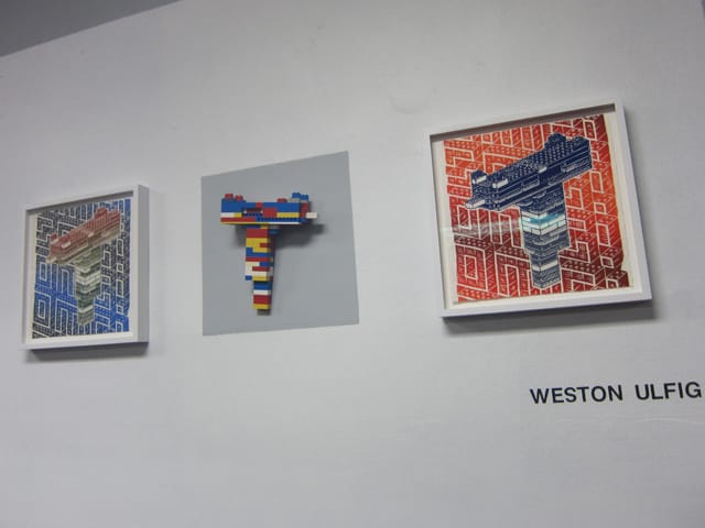 Prints and a lego gun by Weston Ulfig, also part of the "Magic Kingdom" exhibition