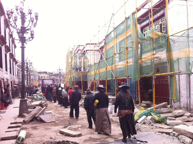 Tibetans walking on the Barkhor amid construction