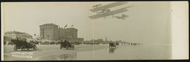 [Car on beach with airplane overhead, probably in Daytona, Florida] Date Created/Published: Daytona, Fla. : H. Marshall Gardiner ; c1911.