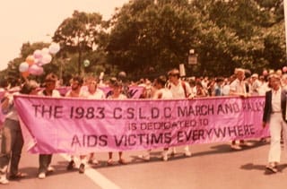 David Bookstaver/Associated Press, gay pride parade in New York City with marchers carrying a banner dedicated to “AIDS victims everywhere,” July 26, 1983 (click to enlarge)