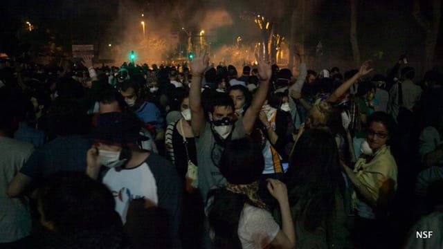 Unintimidated protesters slowly move back from police teargas. (photo: Nazim Serhat Firat, and used with permission)