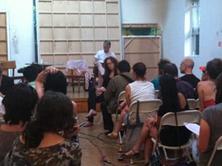 Paddy Johnson listens to an audience member speak at the meeting. (click to enlarge)