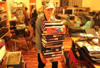 Jonas Mekas with his Litigation Binders, June 2013 (click to enlarge) (via microscopegallery.com)