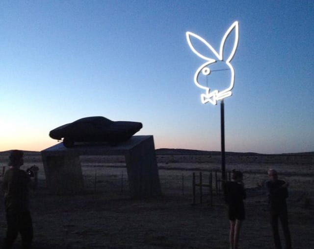 The new neon Playboy bunny and the concrete "box" and car just outside Marfa, Texas. (image courtesy Marfa Public Radio and used with permission)
