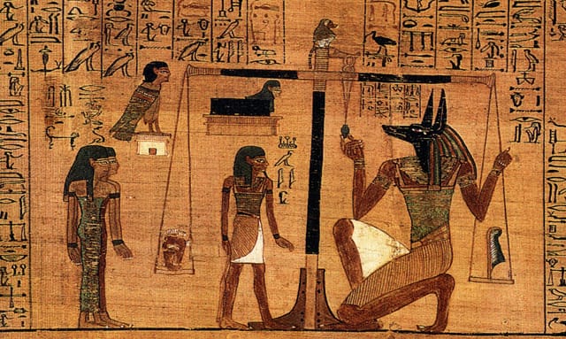 Weighing of the heart of the deceased in the Book on the Dead, written on papyrus (via the British Museum/Wikimedia)