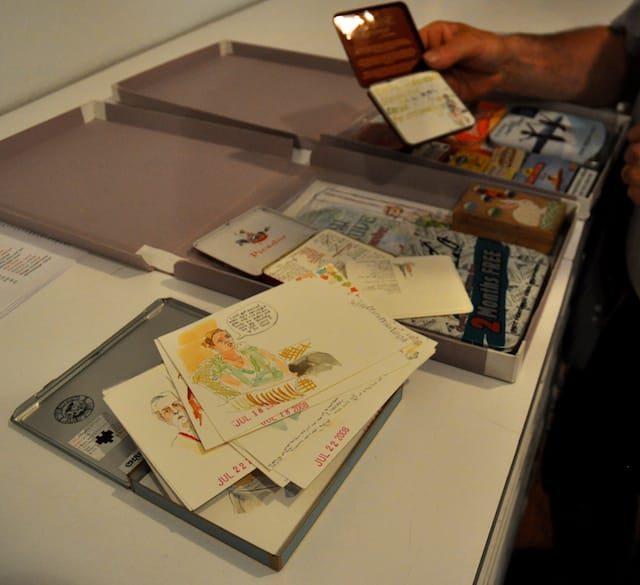 Amrhein showing off the intricate small boxed works by Charmaine Wheatley.