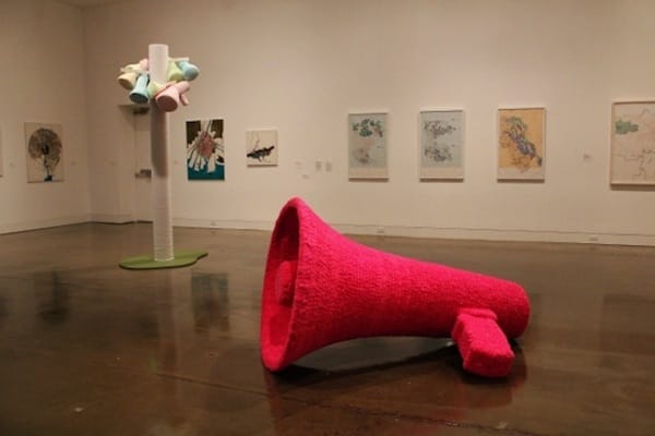 Tiffany Chung is a Vietnamese artist who works with lowbrow decorative items such as pompons, sequins and beads. Seen here, a pair of sculptural pieces — inspired by bullhorns and loudspeakers — that speak to a mood of protest.