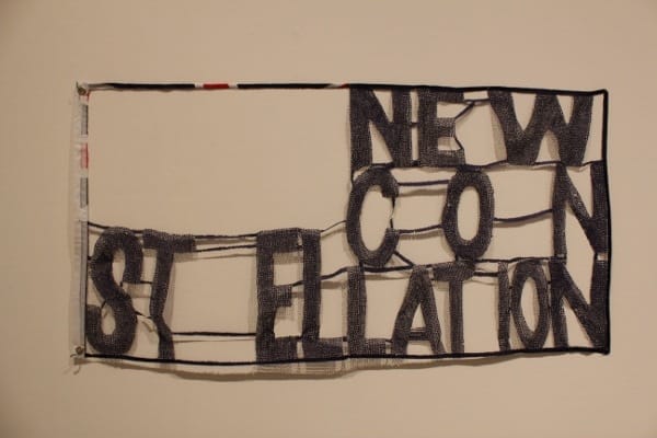 In the hands of Australian artist Raquel Ormella, a flag is turned into a delicate lace by burning out little holes bit by bit.