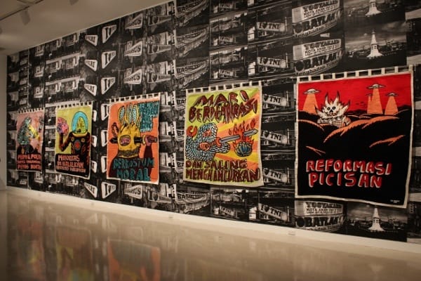 A wall-sized installation by Indonesian artist Eko Nugroho presents political aphorisms in a wild installation featuring some pretty spectacular embroidery. (Sample text: “Mints & Politic both contain Artificial Sweetener”).