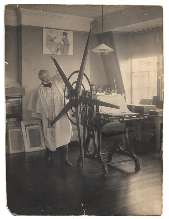 Joseph Pennell working a printing press in his studio (photograph by Joseph Klima, Jr., via Smithsonian Institution)