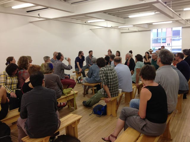 Artist talk on the benches at Murray Guy, with Francis Cape center left, drinking from a water bottle (photo by the author for Hyperallergic)