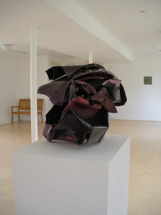 John Chamberlain, "It Ain't Cheap," with a small metal painting on view in the back right (click to enlarge)