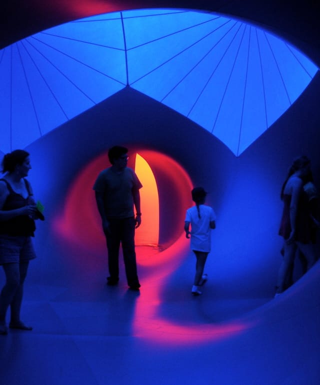 Inside the Luminarium, a blow-up structure filled with different-colored glowing rooms