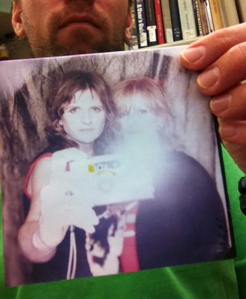 Timothy Garrison taking a photo of an Indigo Girls album