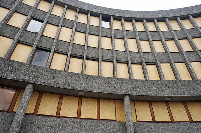 Boarded up windows post-2011 bombing on the Erling Viksjø-designed building that has the Picasso "Fishermen" mural (viaRune Aakvik/Oslo Museum)