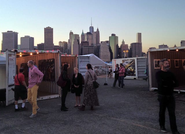At Photoville, with the lower Manhattan skyline in the background. (all images by the author for Hyperallergic)