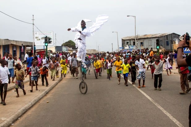 Artist Abrakoah performs as an angelic unicyclist in James Town, Ghana. Photo by Selorm Jay, via Africa is a Country.