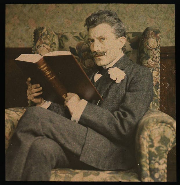 1915 photograph of a gentleman reading (via George Eastman House)