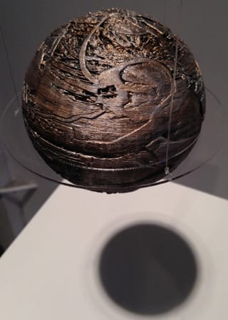A 3D printed sphere hangs in the gallery.