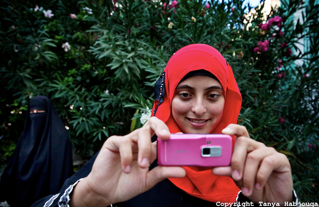 Tanya Habjouqa, from the series "Women of Gaza." Text: "An English literature student at the Islamic University in Gaza takes a break with fellow students. She is eager to apply her English skills and says that her dream is to travel the world. The siege on Gaza makes travel near impossible for the vast majority of Gazans." (all images courtesy of the artist unless otherwise noted)