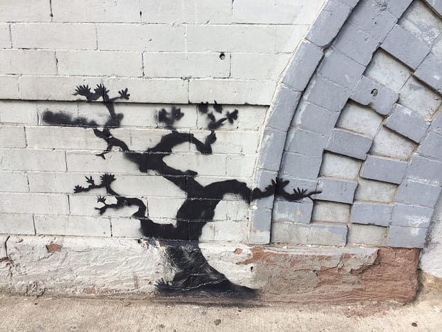 A detail of the Graham Avenue Banksy