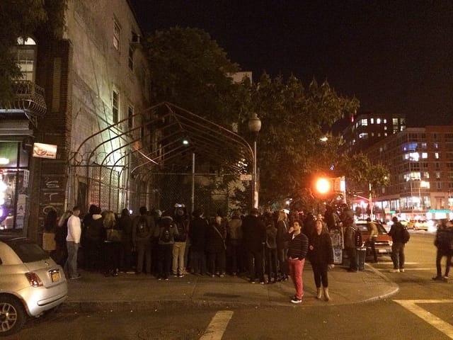 The crowd around Banky's "Reaper" piece at roughly 10:40pm EDT on Friday, October 25, 2013 (all images and videos by the author for Hyperallergic unless otherwise noted)