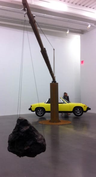 Chris Burden, "Porsche with Meteorite" (2013). Restored 1974 Porsche 914 with 365-pound meteorite, steel frame. Dimensions: 13 ft 6 in x 38 ft 9 in x 13 ft 6 in; car: 3ft 111⁄2in high x 13 ft 6 in long x 5 ft 4 in wide, weight: 2,190 lbs; meteorite: 15 x 17 x 15 in., weight: 365 lbs; steel structure: 13 ft 6 in x 35 ft x 6 ft; 5,025 lbs total. Courtesy the artist