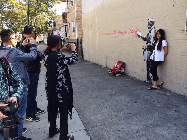 There's something about Banksy that tells people to "bring their kids along" and capture the moment.