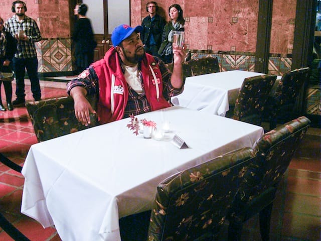 Marco Polo (played by Ashley Faatoalia) at Traxx Restaurant.