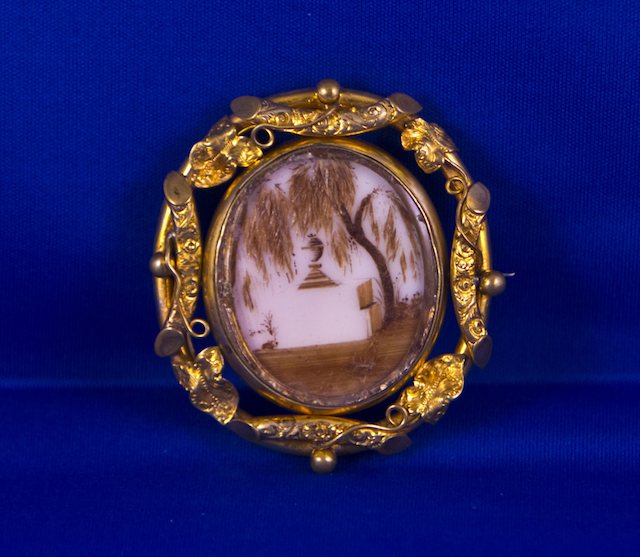 Brooch with embroidered hair