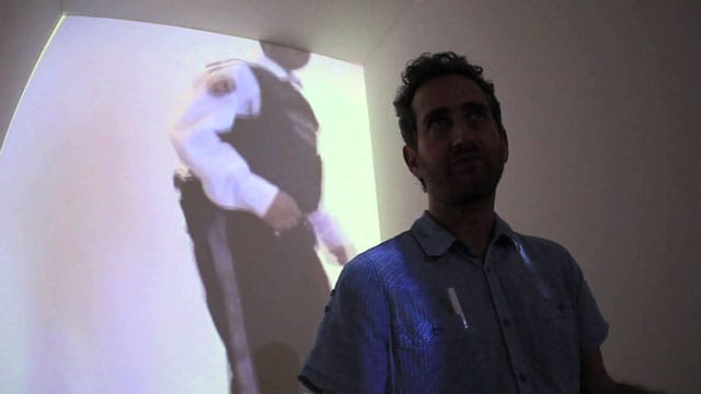 Yoshua Okon in front of his “Orillese a la Orilla” installation