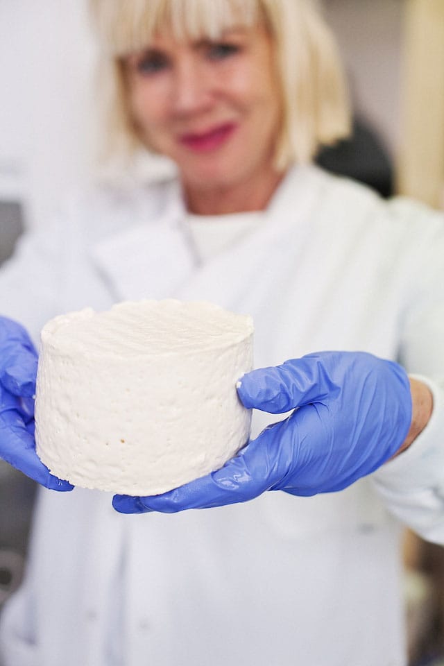Sissel Tolaas holds a cheese that is left to age. (Selfmade by Christina Agapakis and Sissel Tolaas is part of "Grow Your Own: Life After Nature" at Science Gallery at Trinity College Dublin)