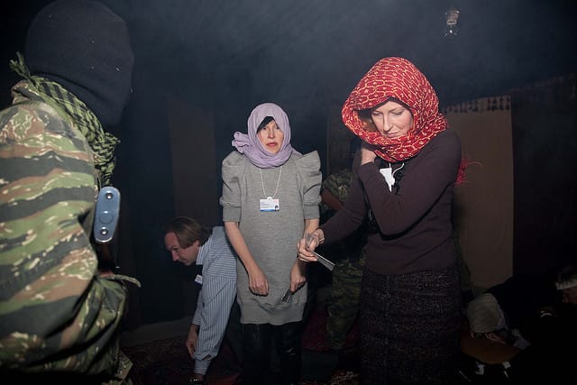 Julia Peyton-Jones as a faux refugee at a Crossroads Foundation "Refugee Run" at Davos, Switzerland, during the World Economic Forum in 2010 (images via Crossroads Foundation Flickrstream)