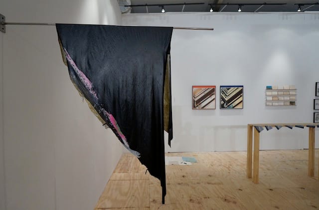 A piece by Duane Bennati, with Redin's postcards visible in the back right