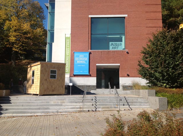 The entrance to the deCordova Sculpture Park and Museum, with John C. Gonzalez's "Home Depot House" at left and one of Pat Falco's signs in the window (all photos by Martha Buskirk)