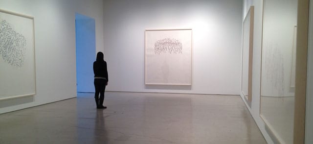 Attendant at Hauser + Wirth, New York City, views Roni Horn’s But 3 (2013), to her left is But 1 (2013).
