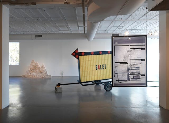 From left to right: Assaf Evron, "Untitled (Egyptian Embassy Tel Aviv)," 2013. Dry wall, split-face blocks, and acrylic. 6' x 5'; Conrad Bakker, "Untitled Project: SIGN [Relax and Take Your Fucking Time]," (2013), oil paint on carved wood, 82 x 108 x 58 inches; Aaron Van Dyke, "Untitled" (2013), inkjet print (double-sided), 42 x 64 inches. All images courtesy of Hyde Park Art Center unless otherwise noted.