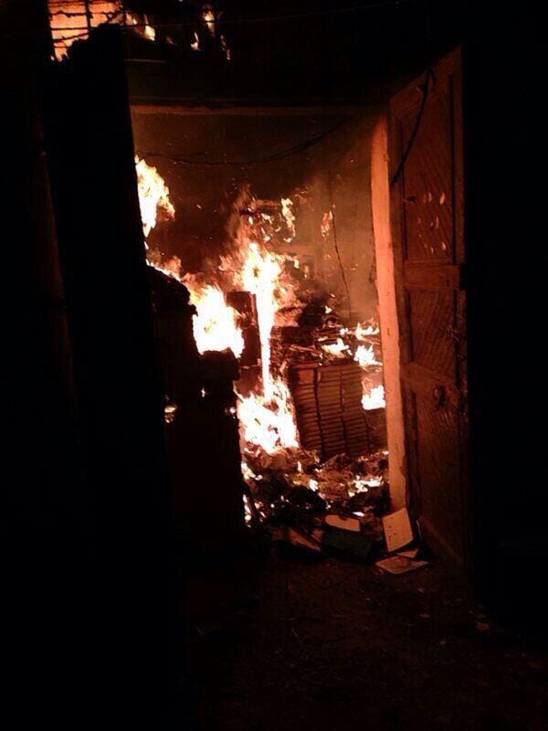 A photo of the Al-Saeh library on fire (image via @Lara_alassaad on Twitter, who says it comes unattributed via Facebook)