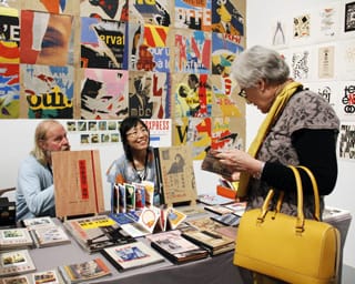 A visitor to last year's LAABF peruses the colorful material. (via Printed Matter)