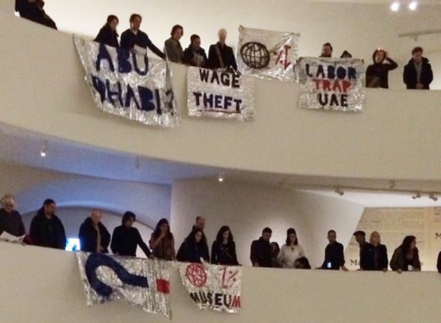 A close-up of some of the banners unfurled during the Saturday, February 22 intervention by G.U.L.F. at the Guggenheim Museum in Manhattan. (photo by the author for Hyperallergic)