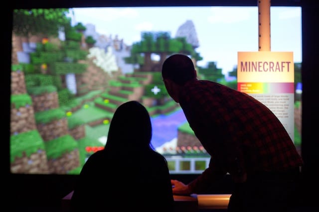 Visitors playing MINECRAFT (2011) in the exhibiton "Indie Essentials: 25 Must-Play Video Games" co-presented by Museum of the Moving Image and IndieCade. On view at the Museum through March 2, 2014. Photo: Ben Helmer.