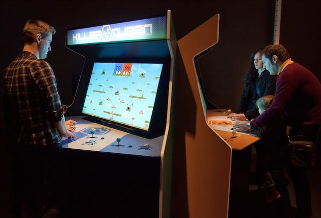 Visitors playing KILLER QUEEN ARCADE (20012) in the exhibiton "Indie Essentials: 25 Must-Play Video Games" co-presented by Museum of the Moving Image and IndieCade. On view at the Museum through March 2, 2014. Photo: Ben Helmer.
