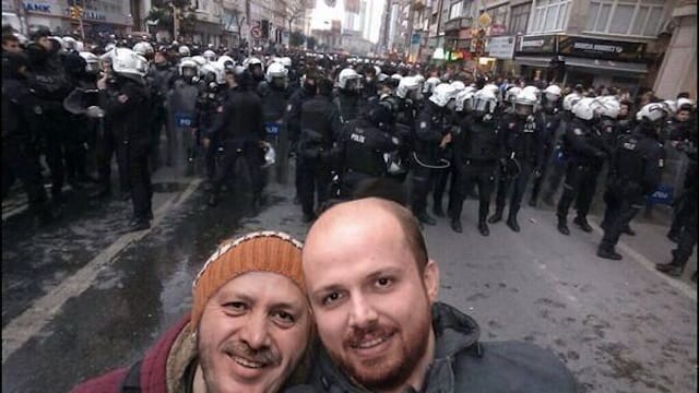Fake selfie of Erdogan and his son Bilal in front of police at a protest in Istanbul. Image via Twitter.
