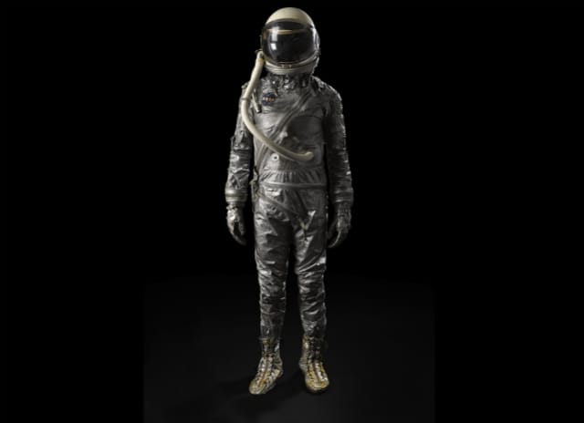 MERCURY ERA SPACESUIT. Cover layer from a Phase 2 Mercury era space suit, with early model "widow's peak" helmet and gloves.  Est. $8,000-12,000