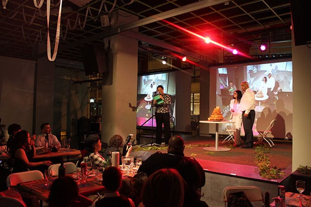 Edra Soto recites her love poem for the couple before slicing into the wedding cake.