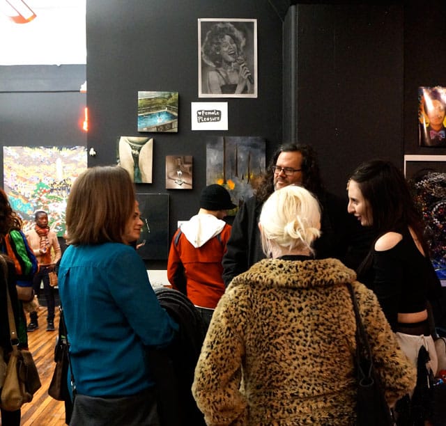 A portrait of Whitney watches over the crowd.