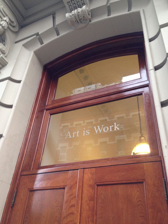 The door to Glaser's building, bearing his motto (photo by the author for Hyperallergic) (click to enlarge)