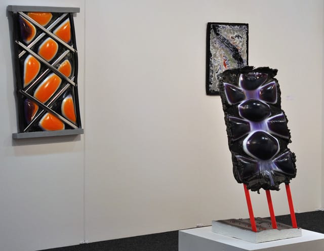 Jesse Greenberg's "Face Stamp in Suspension" (2014) and "Face Stamp in Stance" (2014) resin, pigment, bbs, metal, and paint works at Loyal gallery of Malmö, Sweden.