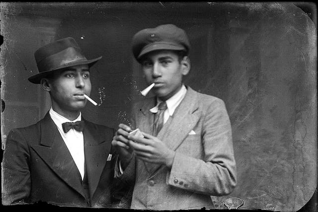 Two men smoking (via Costică Acsinte Archive)